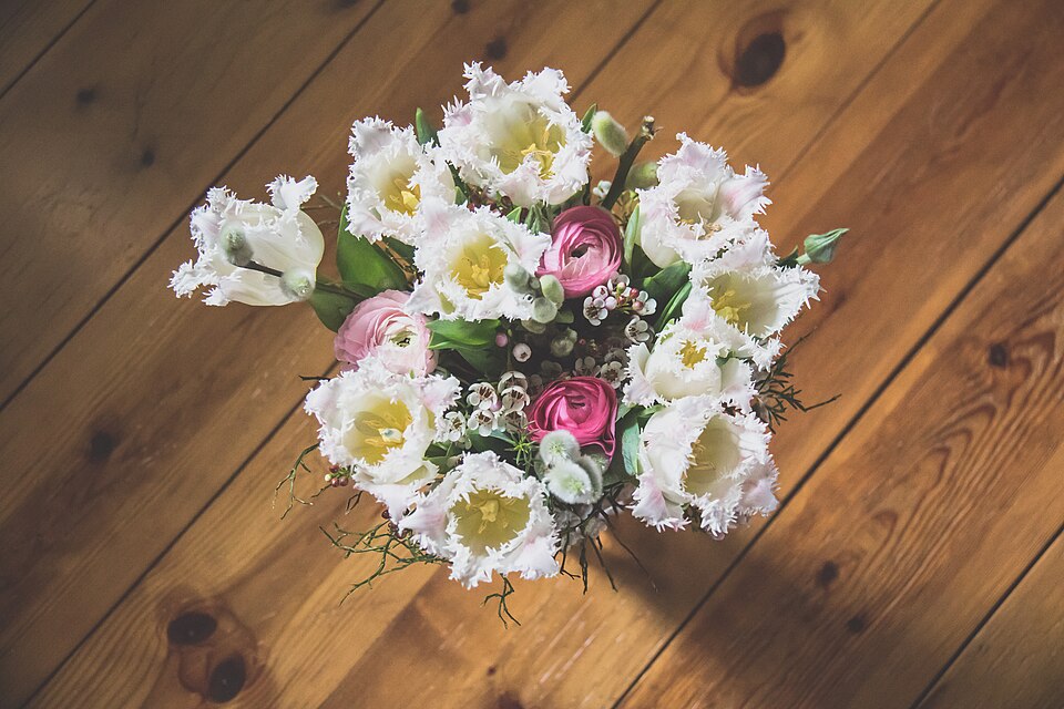 White bouquet of ranunculus and tulips with pink touches